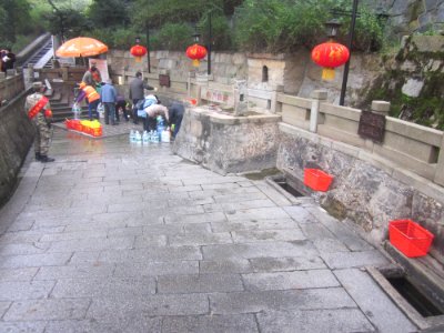 People scooping water out of the Baisha Well, picture2
