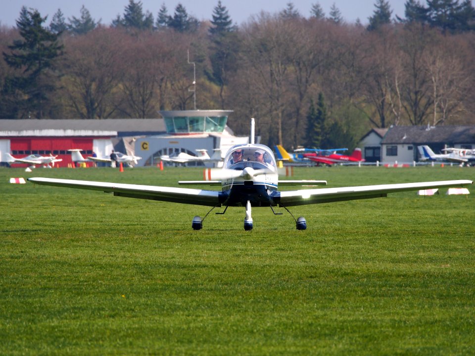 PH-VHA, Tecnam P2002 Sierra with tower of Hilversum Airport (ICAO EHHV), photo2