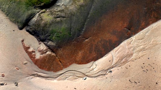 Sand formed by water below a cliff in Govik 1
