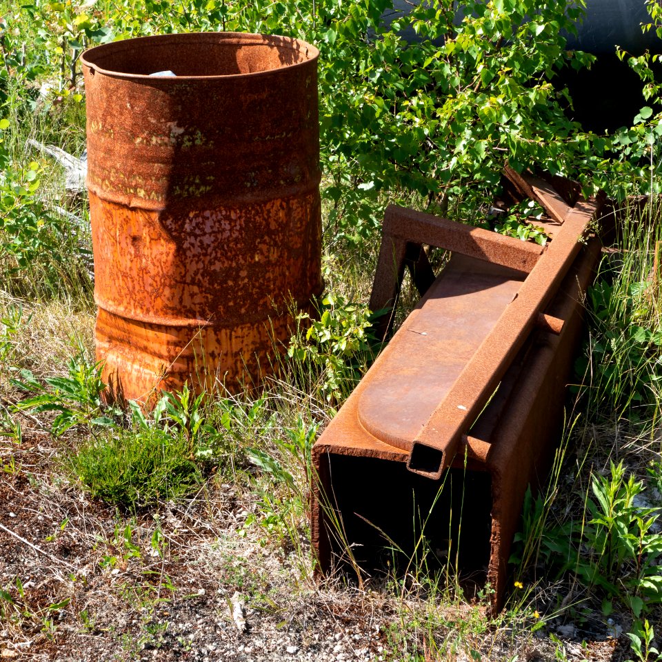 Rusty oil drum and scrap metal