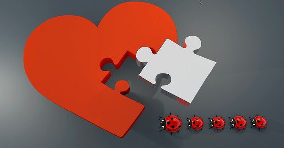 Joining together puzzle piece heart shape photo