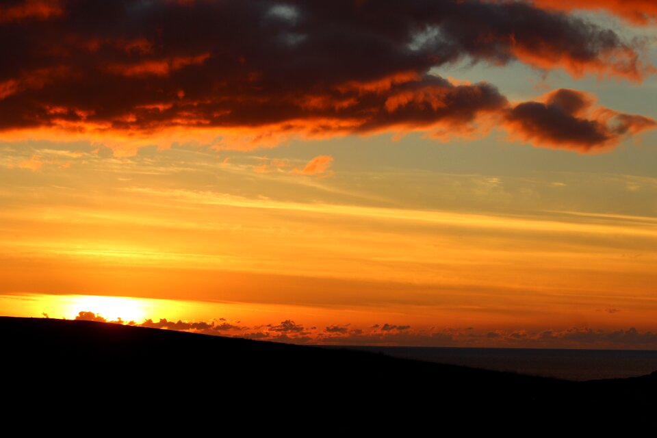 Red clouds sky fire coast
