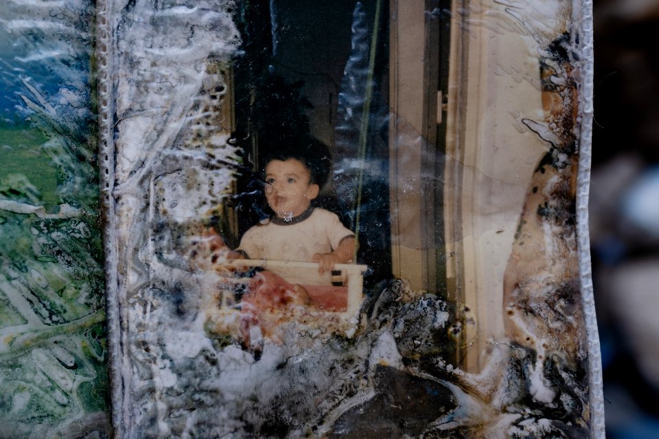 Ruined photos left behind by a Muslim family in Shingal (Sinjar) found in a destroyed home after war with the Islamic State 14