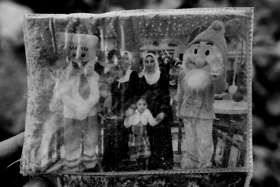 Ruined photos left behind by a Muslim family in Shingal (Sinjar) found in a destroyed home after war with the Islamic State 10