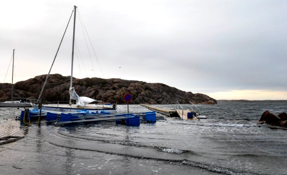 Sailboat and jetty floating above the quay in Valbodalen harbor during Storm Ciara