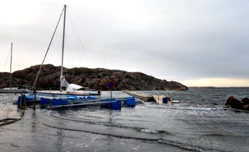 Sailboat and jetty floating above the quay in Valbodalen harbor during Storm Ciara photo