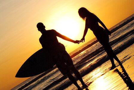 Surf holding hands romantic photo