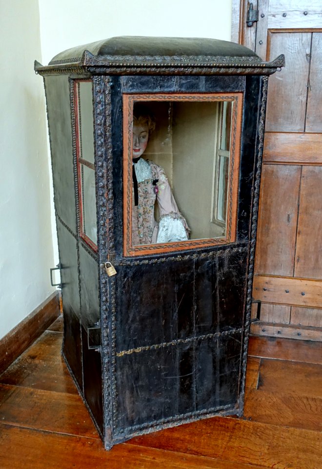 Sedan chair, 1755-1762, wood frame, leather panels, wool cloth upholstery - Packwood House - Warwickshire, England - DSC08878