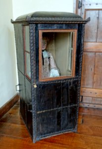 Sedan chair, 1755-1762, wood frame, leather panels, wool cloth upholstery - Packwood House - Warwickshire, England - DSC08878
