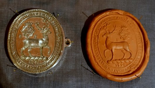 Seal and impression, Derby almshouse lands endowed by Elizabeth, Countess of Shrewsbury, 1598, silver, modelling clay - Oak Room, Chatsworth House - Derbyshire, England - DSC03066