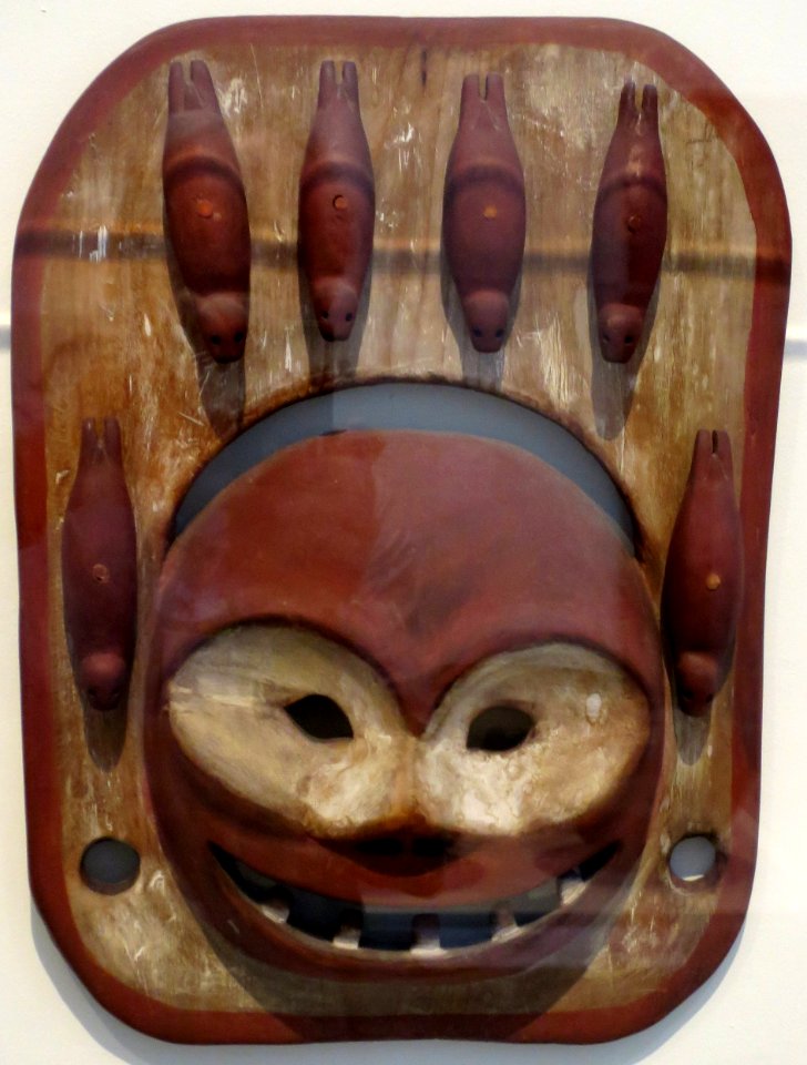 Seal mask, Eskimo, early 20th century, carved wood, red and white pigments, whale ivory