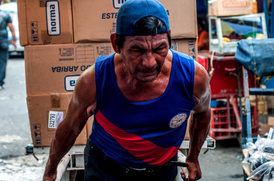 Senior man transporting cargo on the Market