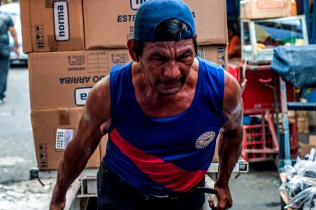 Senior man transporting cargo on the Market