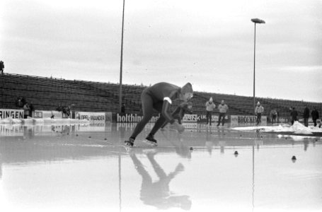 Schaatser in actie, op de achtergrond lege tribunes, Bestanddeelnr 926-9364