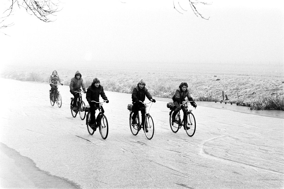 Schaatsplezier in Noord Holland kinderen op de fiets over het ijs naar school, Bestanddeelnr 930-6245