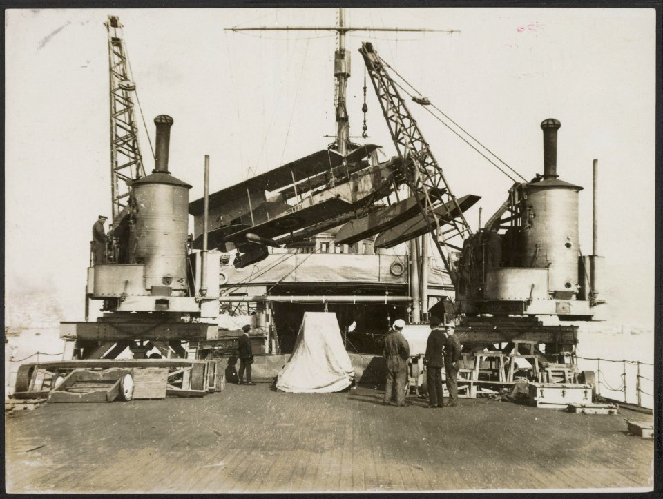 Scene on board of a British seaplane ship. Bringing a seaplane out of the hold., Bestanddeelnr 158-1991