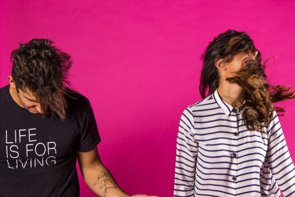 Teens having fun pink background
