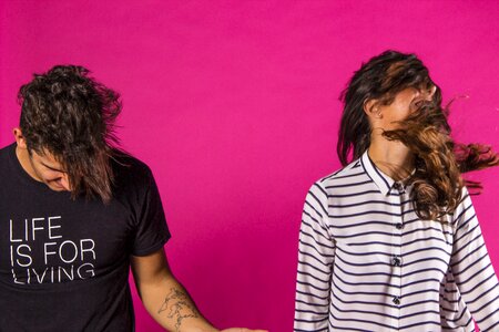 Teens having fun pink background