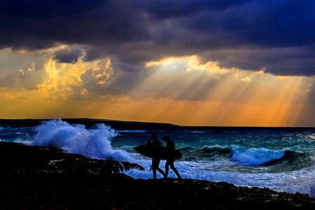 Men surf sea