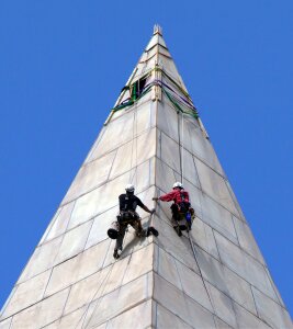 Workers rappelling maintenance