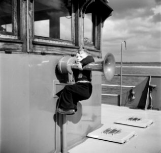 Schipperskind Walter Rieb spelend met de scheepshoorn aan dek van de Damco 9, Bestanddeelnr 254-1415