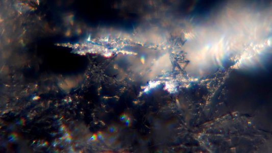 Snow crystals glittering in strong direct sunlight 42 - fancy crop - high contrast