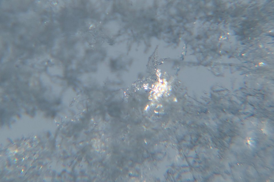 Snow crystals on window glittering in strong direct sunlight 34 - cropped