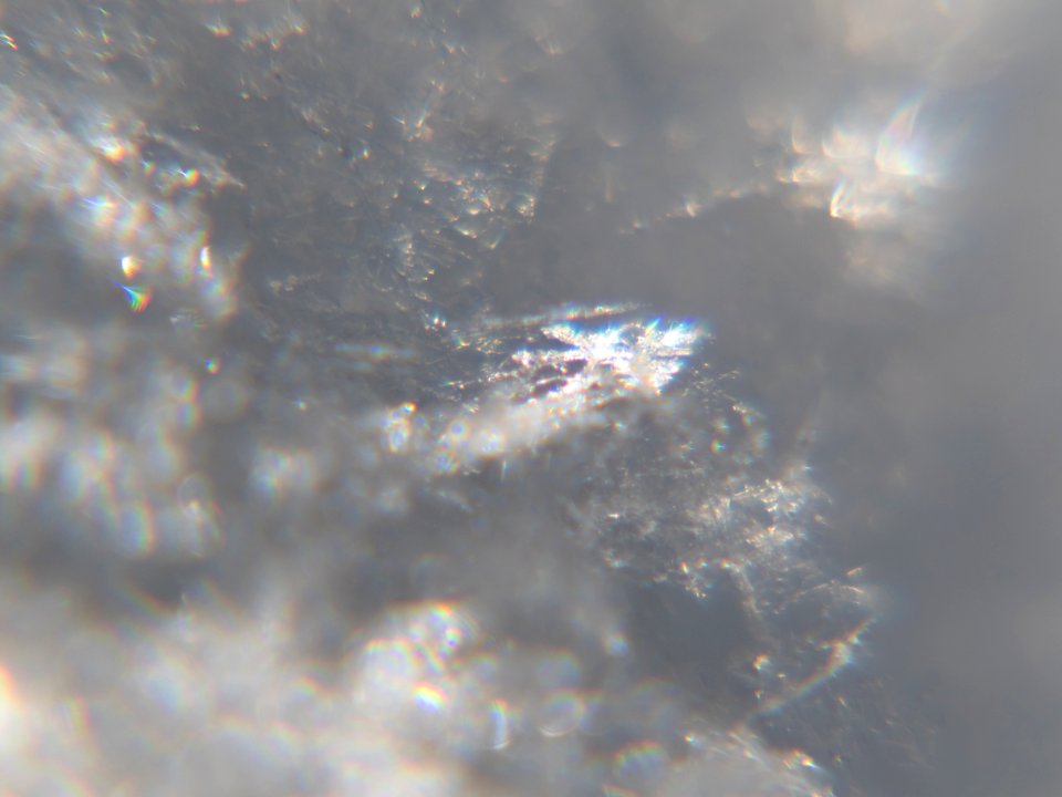 Snow crystals glittering in strong direct sunlight 49