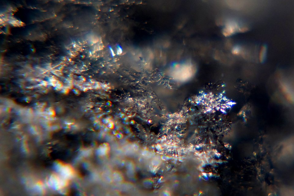 Snow crystals glittering in strong direct sunlight 17 - 18 - cropped - high contrast
