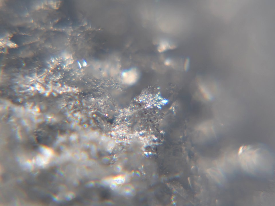 Snow crystals glittering in strong direct sunlight 18