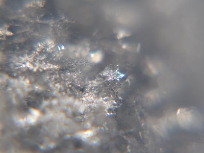 Snow crystals glittering in strong direct sunlight 18