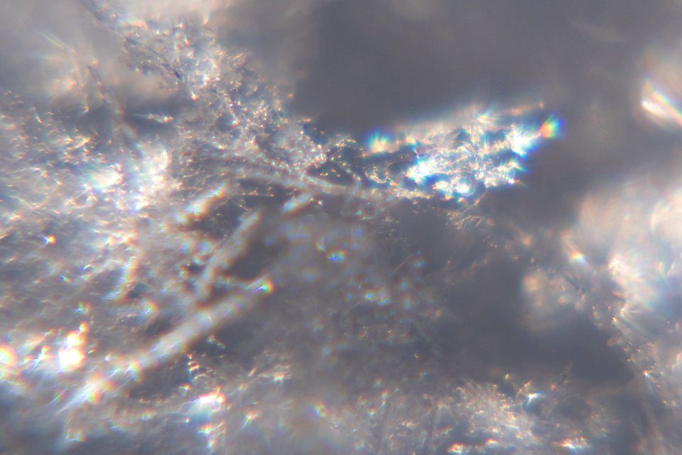 Snow crystals glittering in strong direct sunlight 45 - cropped