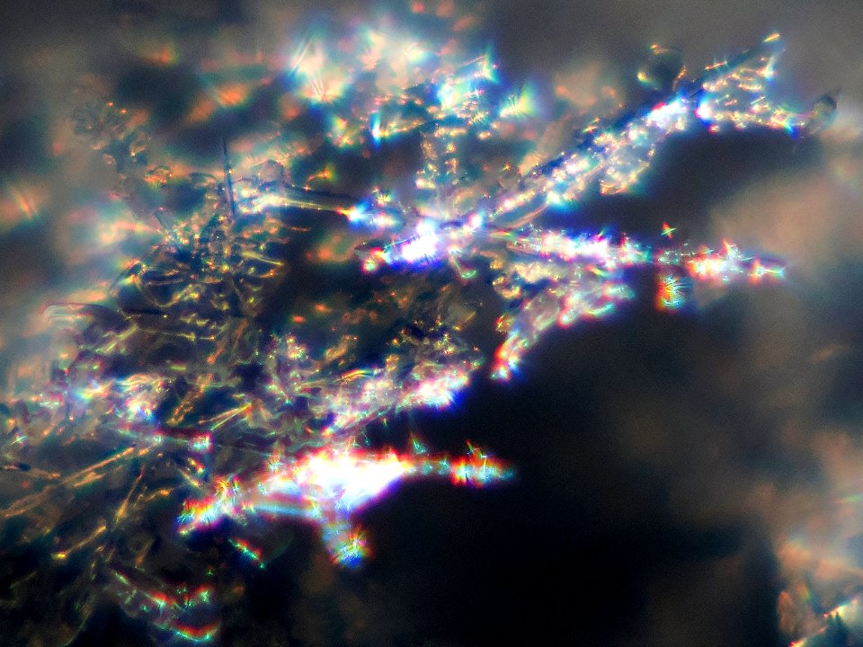 Snow crystals glittering in strong direct sunlight 40 - tight crop - high contrast
