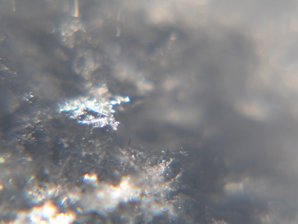 Snow crystals glittering in strong direct sunlight 11