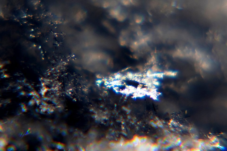 Snow crystals glittering in strong direct sunlight 20 - cropped - high contrast