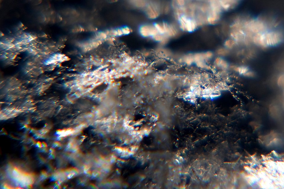 Snow crystals glittering in strong direct sunlight 28 - cropped - high contrast