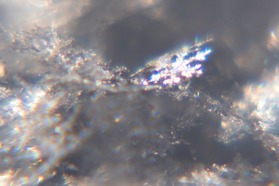 Snow crystals glittering in strong direct sunlight 43 - cropped