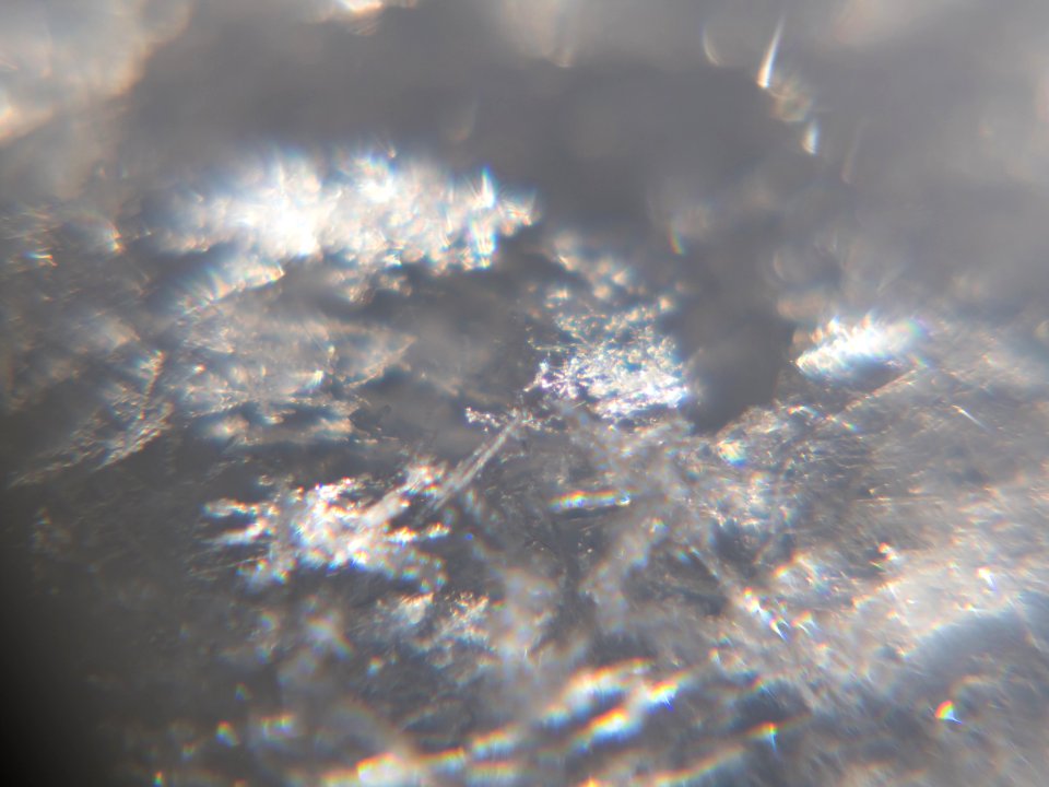 Snow crystals glittering in strong direct sunlight 39