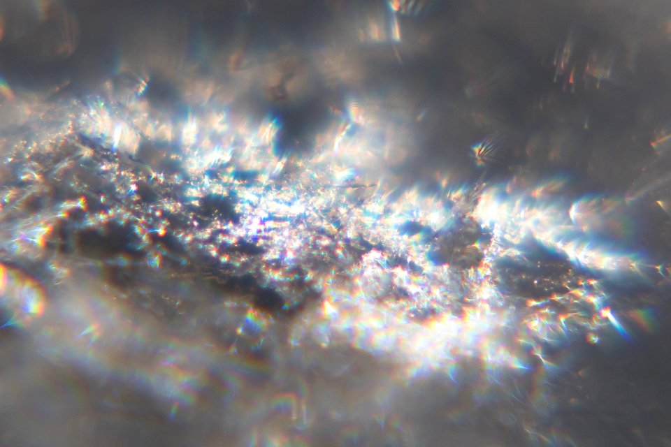 Snow crystals glittering in strong direct sunlight 48 - cropped