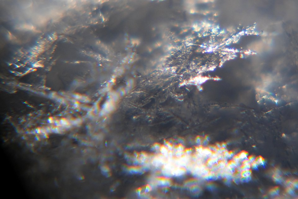 Snow crystals glittering in strong direct sunlight 40 - cropped - high contrast