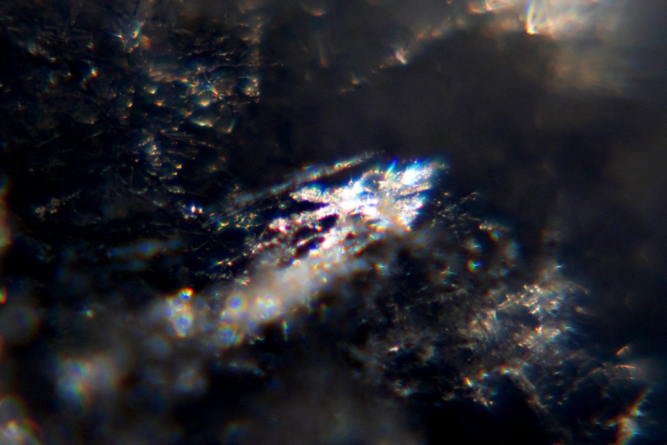 Snow crystals glittering in strong direct sunlight 49 - 50 - cropped - high contrast