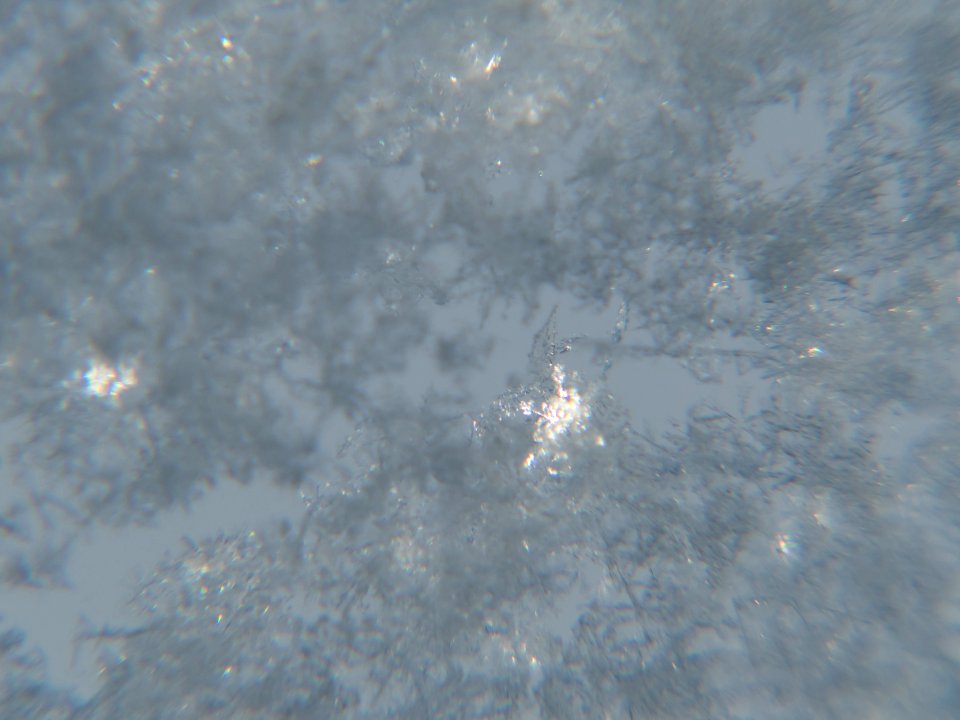 Snow crystals on window glittering in strong direct sunlight 34