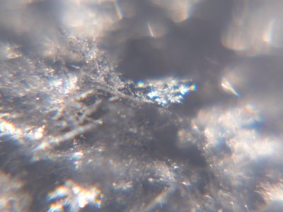 Snow crystals glittering in strong direct sunlight 45