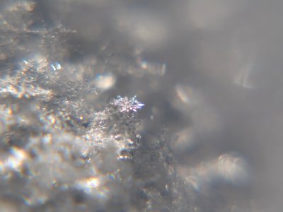 Snow crystals glittering in strong direct sunlight 17