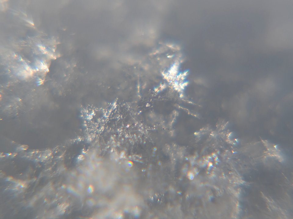 Snow crystals glittering in strong direct sunlight 16