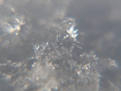 Snow crystals glittering in strong direct sunlight 16