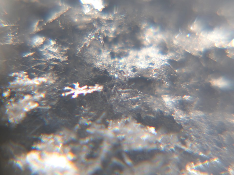 Snow crystals glittering in strong direct sunlight 13