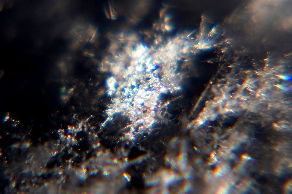 Snow crystals glittering in strong direct sunlight 33 - cropped - high contrast