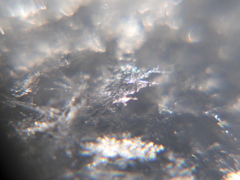 Snow crystals glittering in strong direct sunlight 40