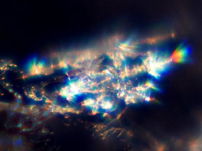 Snow crystals glittering in strong direct sunlight 45 - tight crop - high contrast